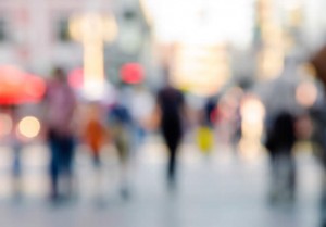 A picture of a town centre, people walking around, blurred so that there is no focus in the image, only colours, shapes and fuzzy things can be seen.