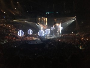 Photo shows view from out seats, it shows the central stage with large lled lit balls attached to drone..... The title of the Tour