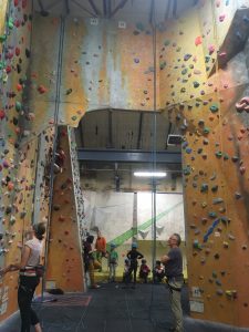 Image showing climbing walls with competitors in the background around the bouldering problems