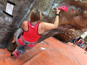 Use of my back, sat crouched on a smalll foot hold with my right arm out to the side holding a large pink hold.