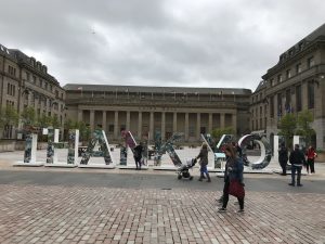 Tall letters on plinths that say THANK YOU, with pictures of men and women who have fought for the country on the front, with the remaining sides left white for people to write their own messages of Thanks.