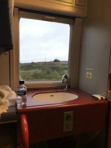 Photograph of the open blind within my birth showing the countryside with the sink and worktop in the foreground 