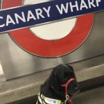 Canary Wharf Roundell with Guide Dog sat in front of it in her guide dog harness.